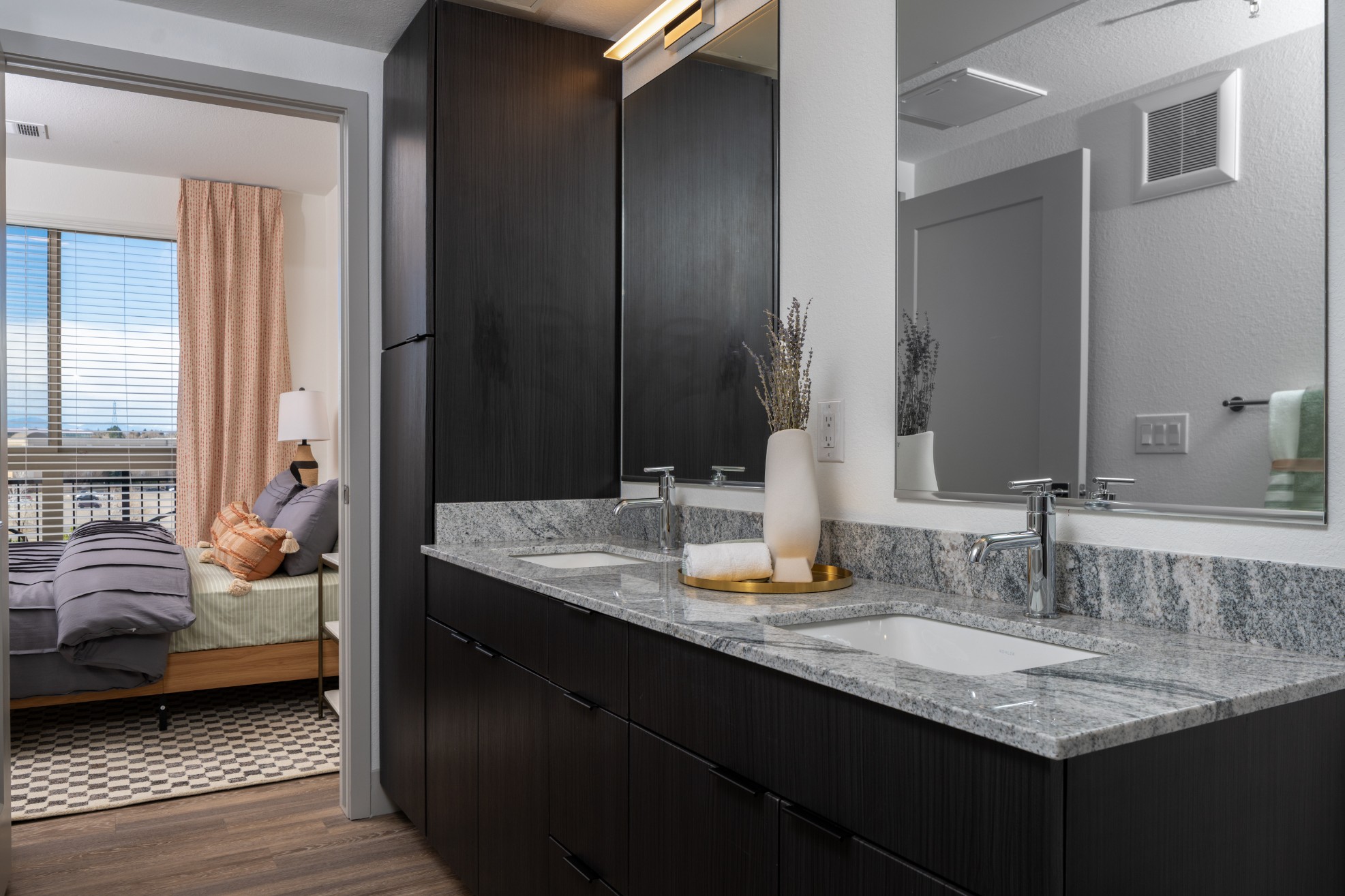 Model bathroom with quartz countertops and double sinks at Legacy Metro 525