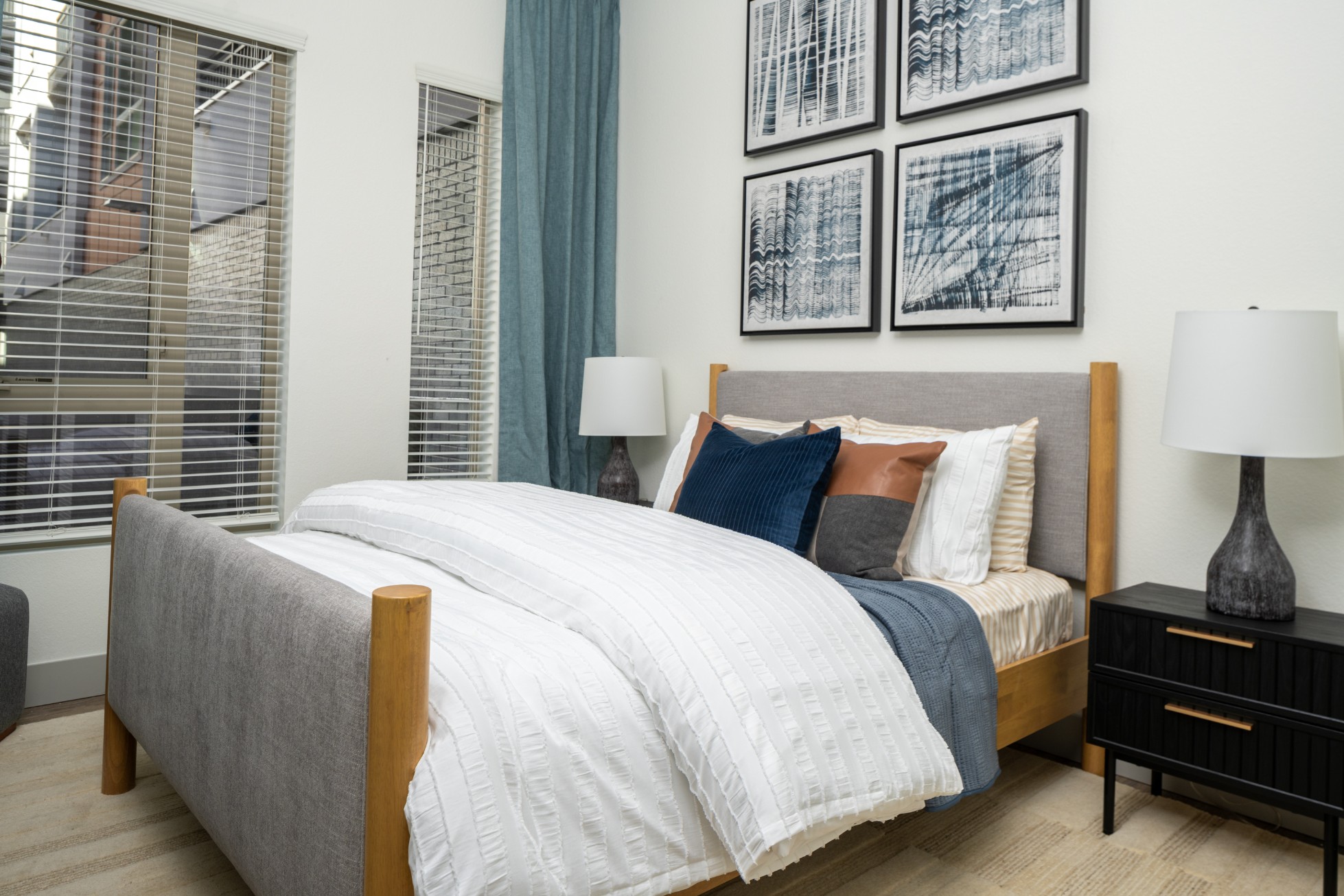 Model bedroom with large windows and high ceilings at Legacy Metro 525