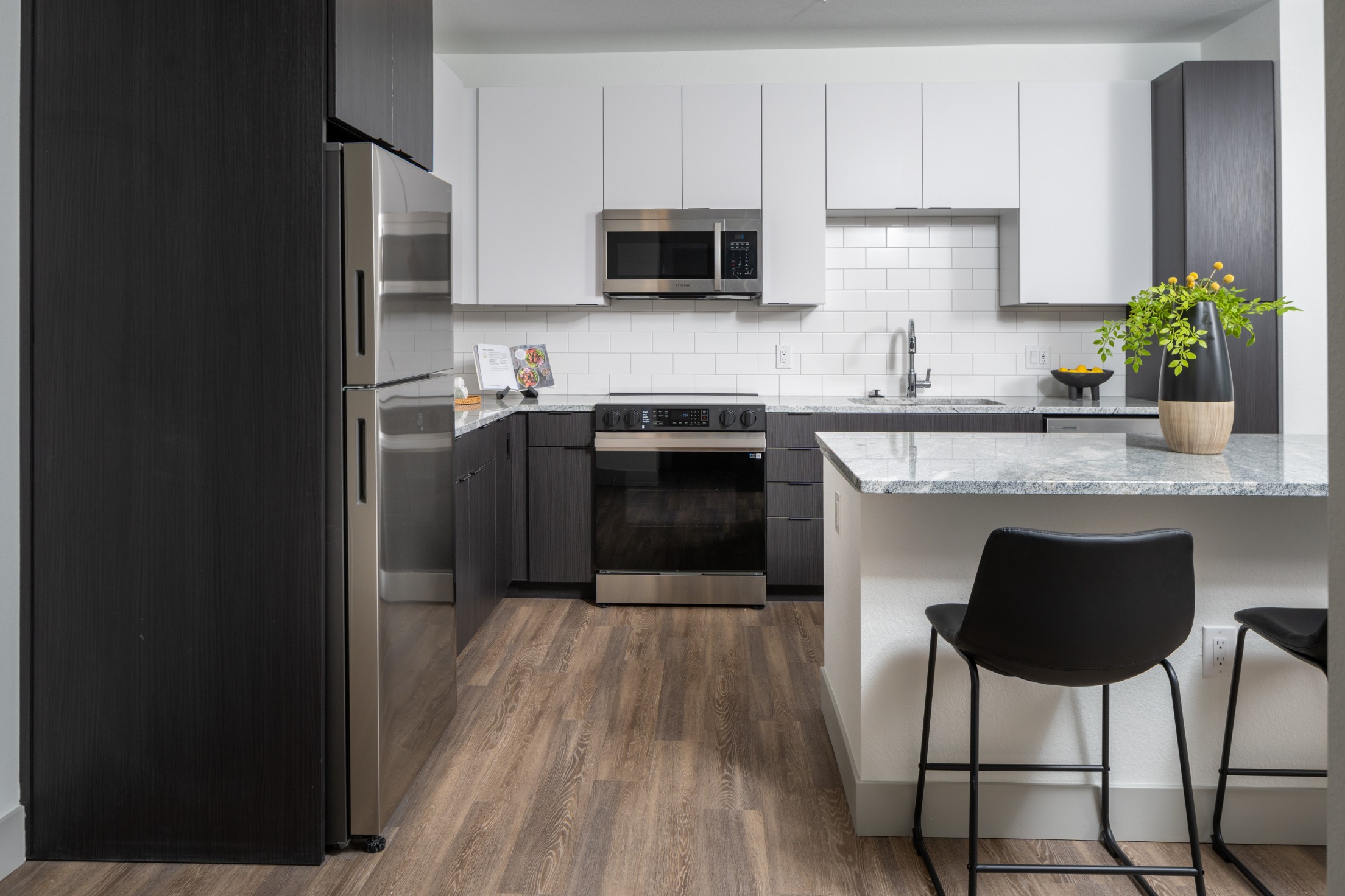 Model kitchen with stainless-steel appliances and tile backsplash