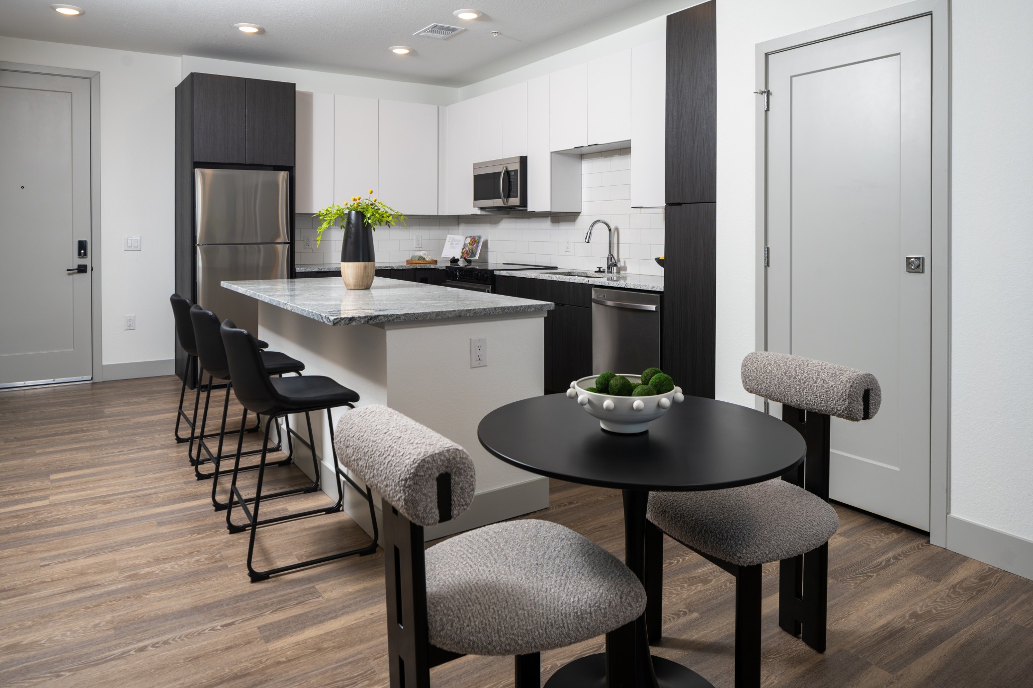 Open kitchen and dining area of a model apartment at Legacy Metro 525