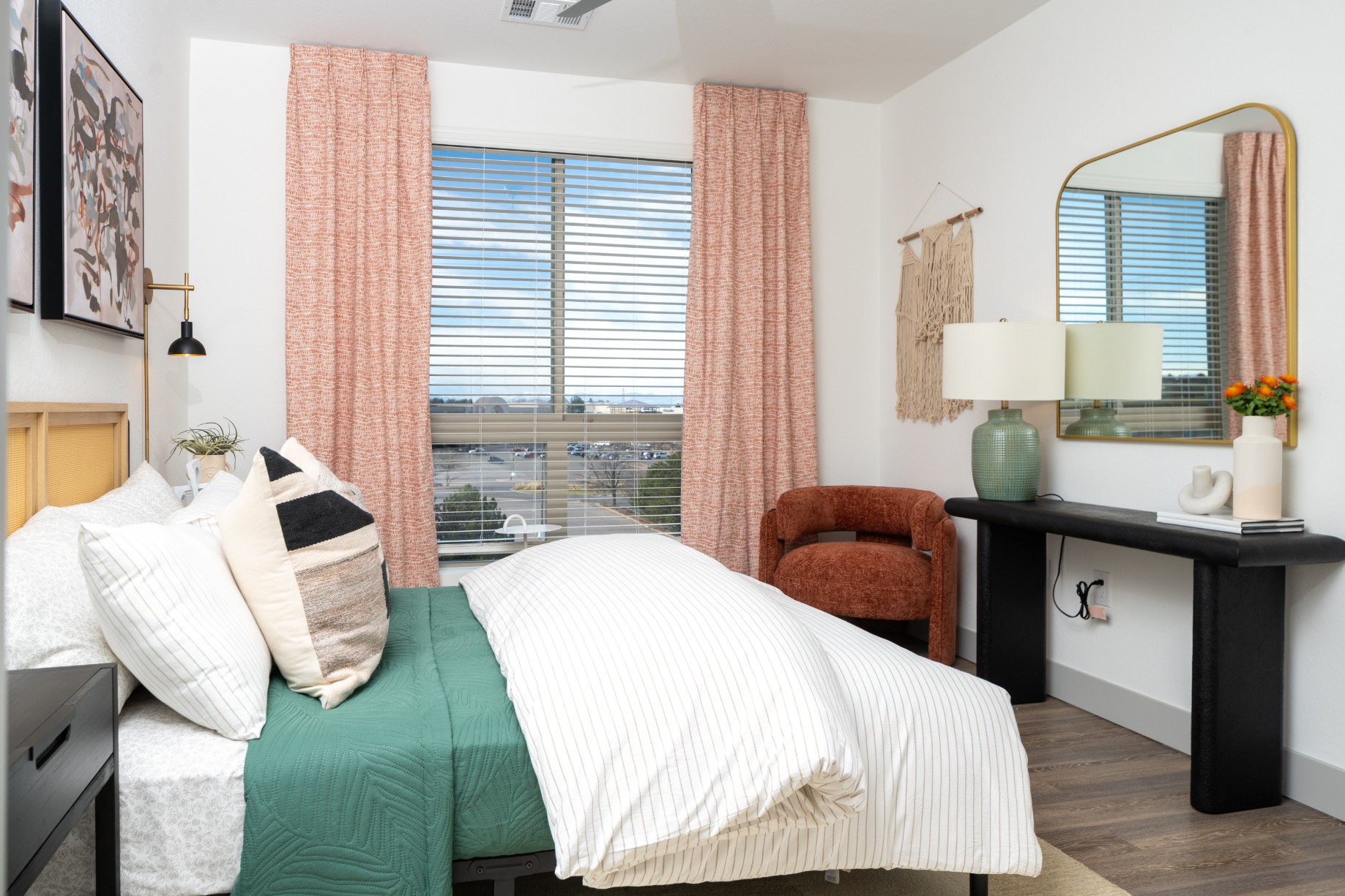 Spacious model bedroom with hardwood-style flooring