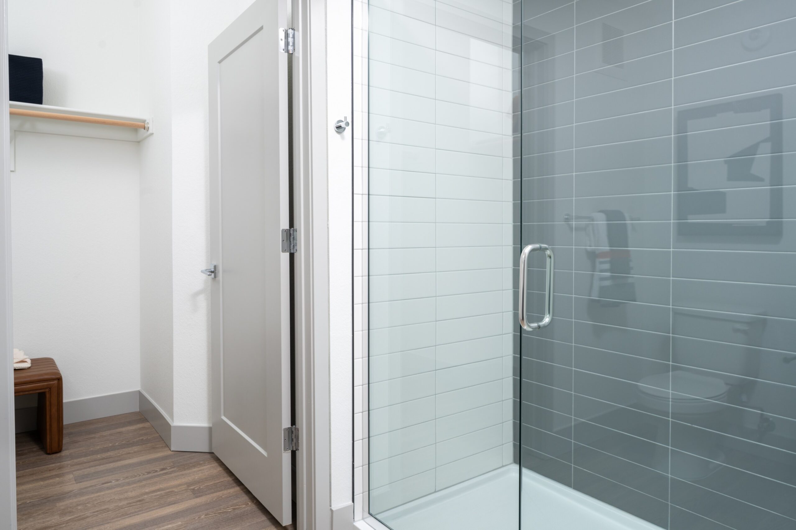 Tiled walk-in shower and walk-in closet in a model apartment at Legacy Metro 525