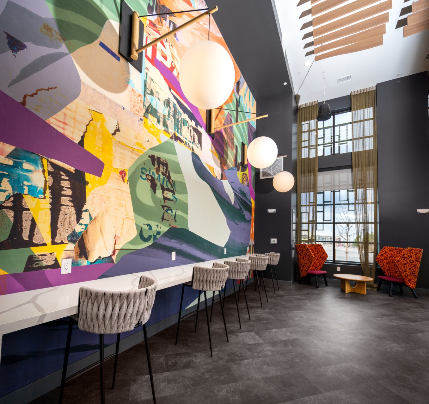Vibrant mural and counter seating in the coffee bar lounge at Legacy Metro 525