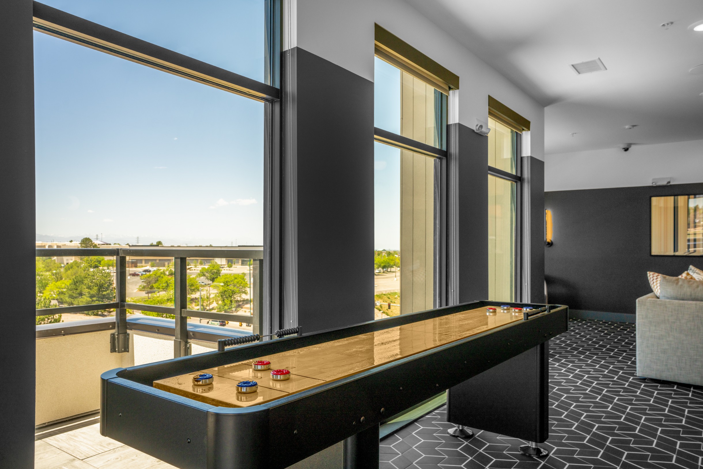Shuffleboard in the clubroom at Legacy Metro 525