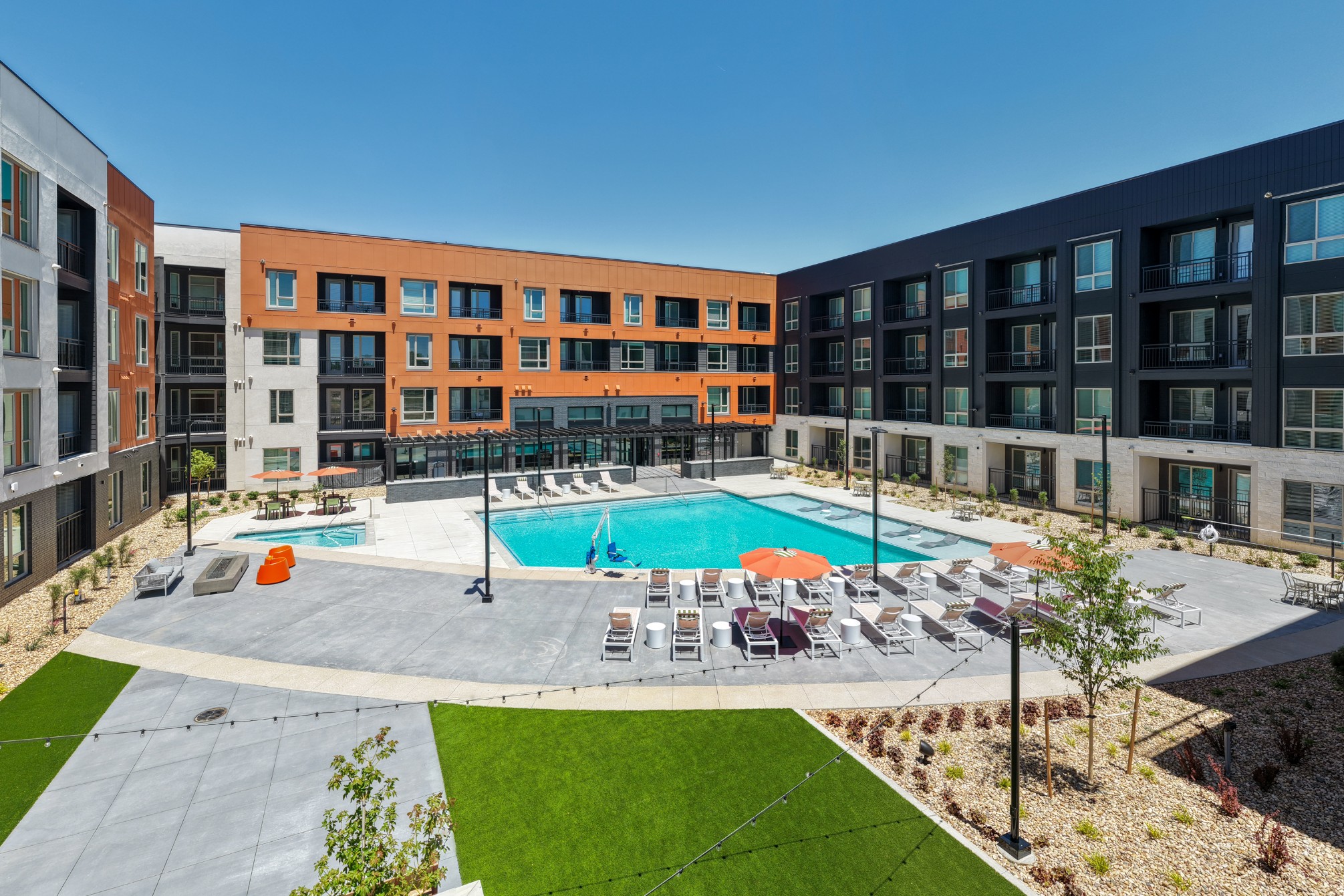 Accessible resort-style swimming pool and sundeck lounge seating