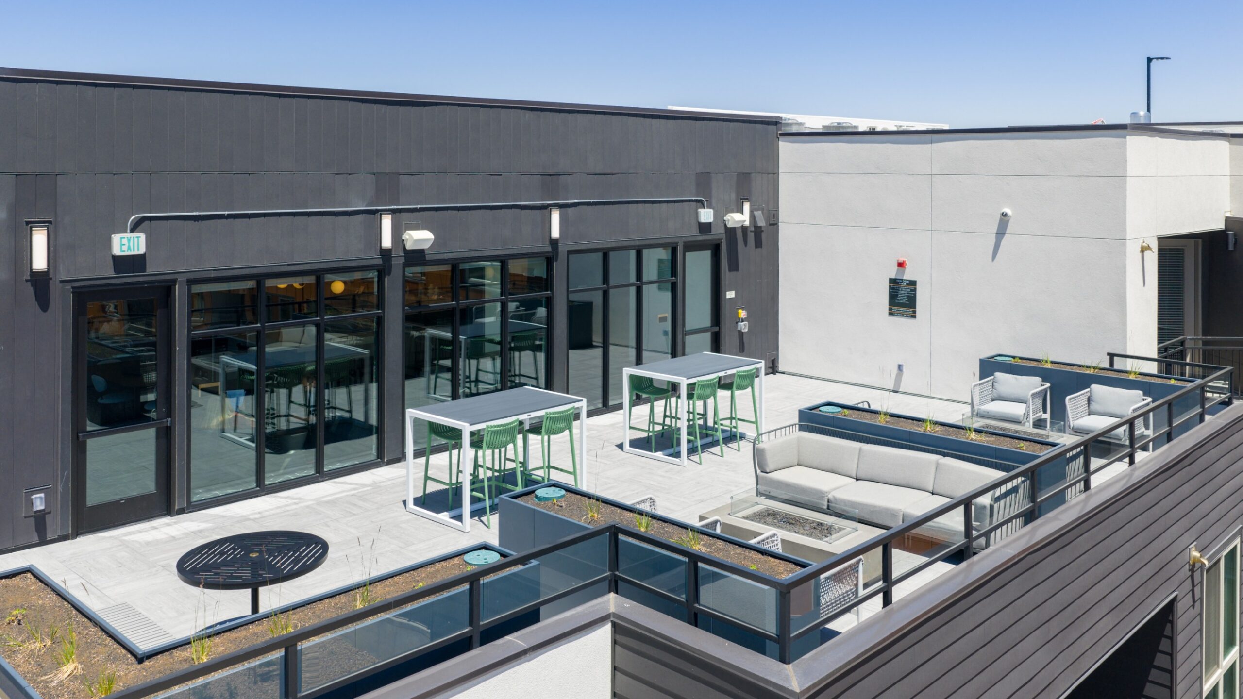 Skydeck with high tables and firepit lounge area