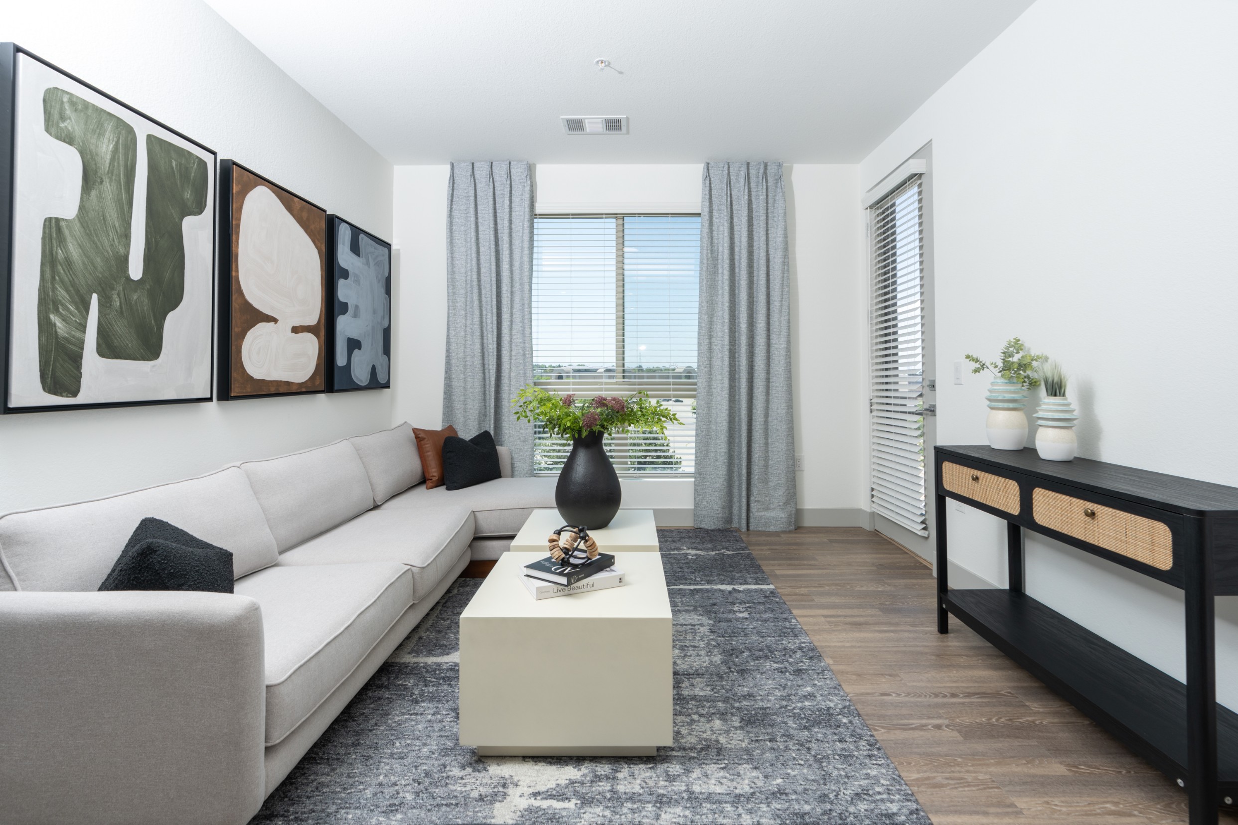 Model living room with hardwood-style flooring