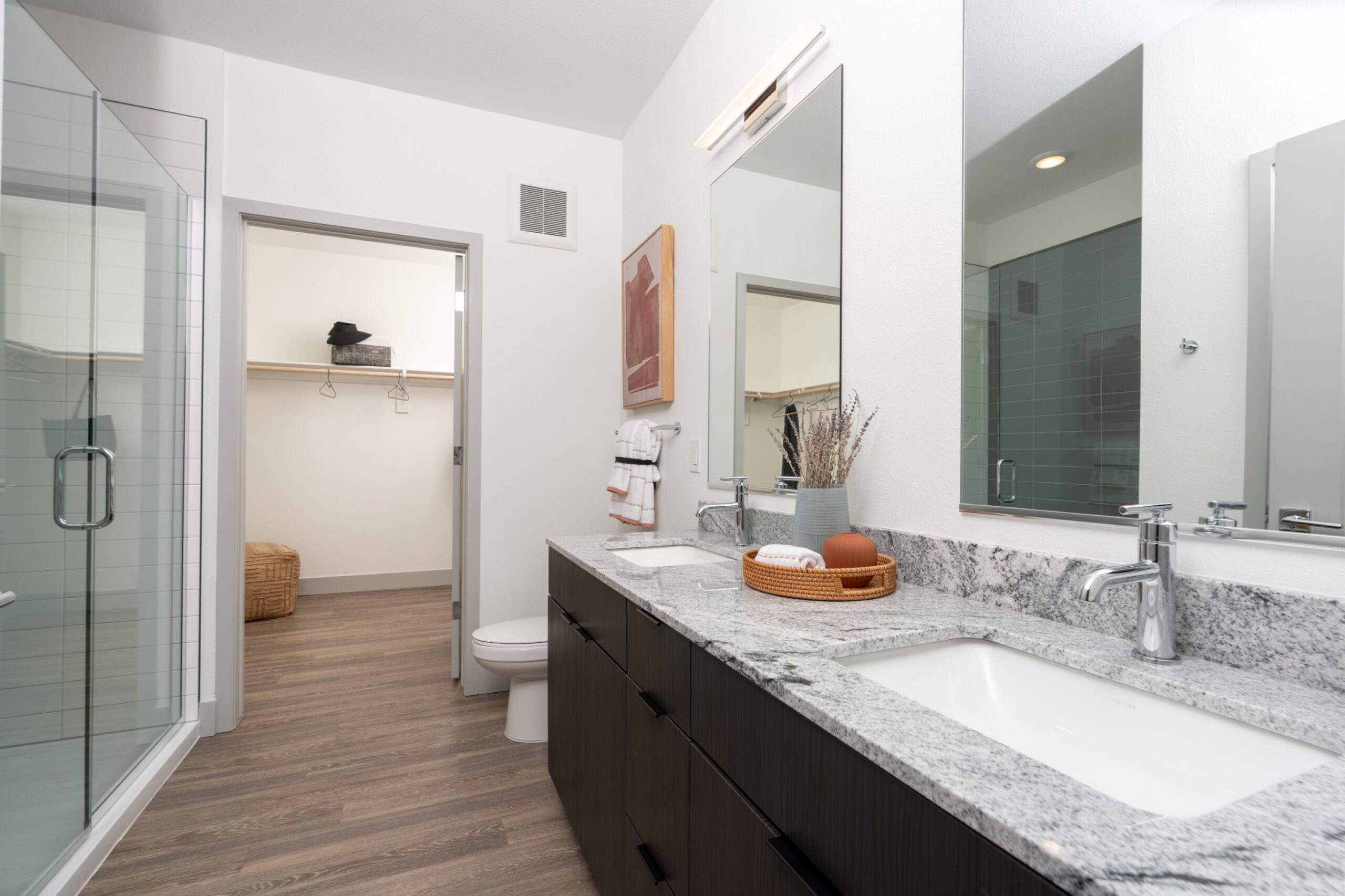 Double vanity with granite countertops and modern hardware fixtures