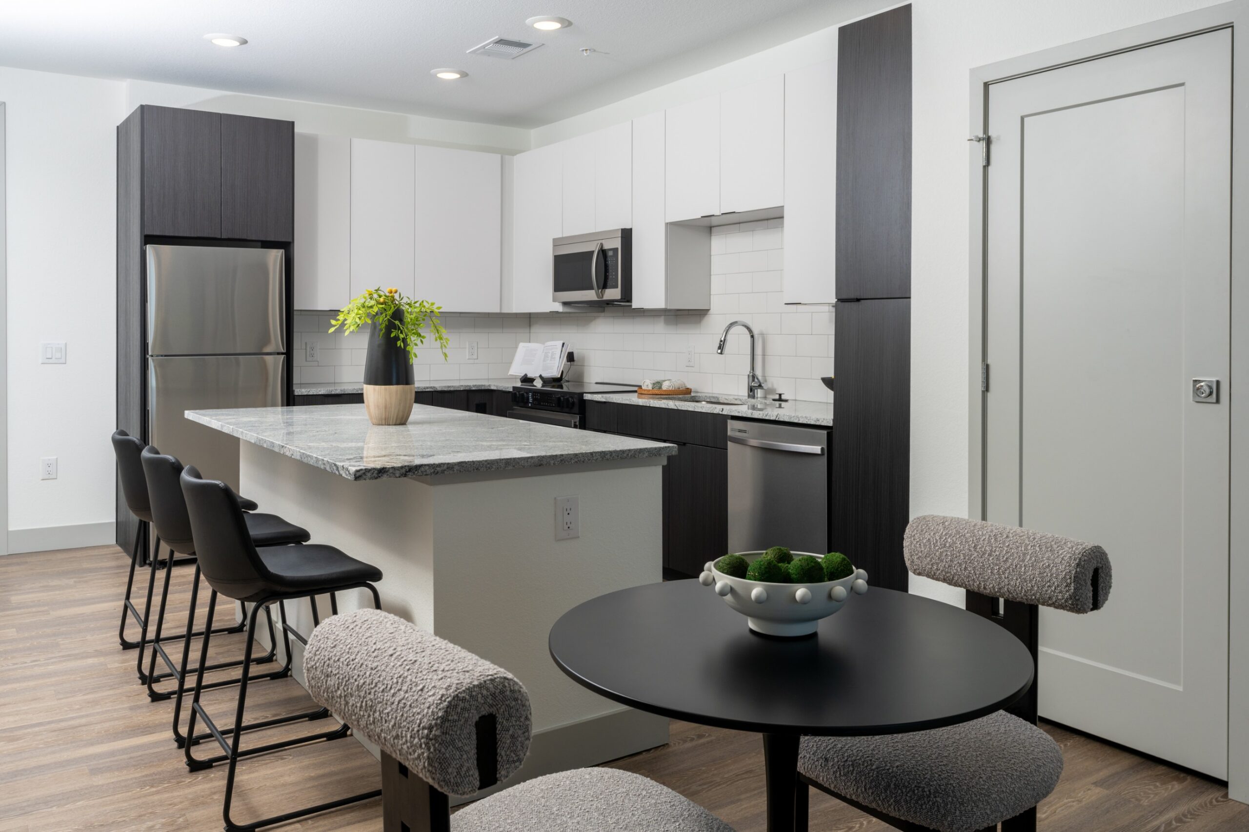 Kitchen and dining area of a model apartment at Legacy Metro 525