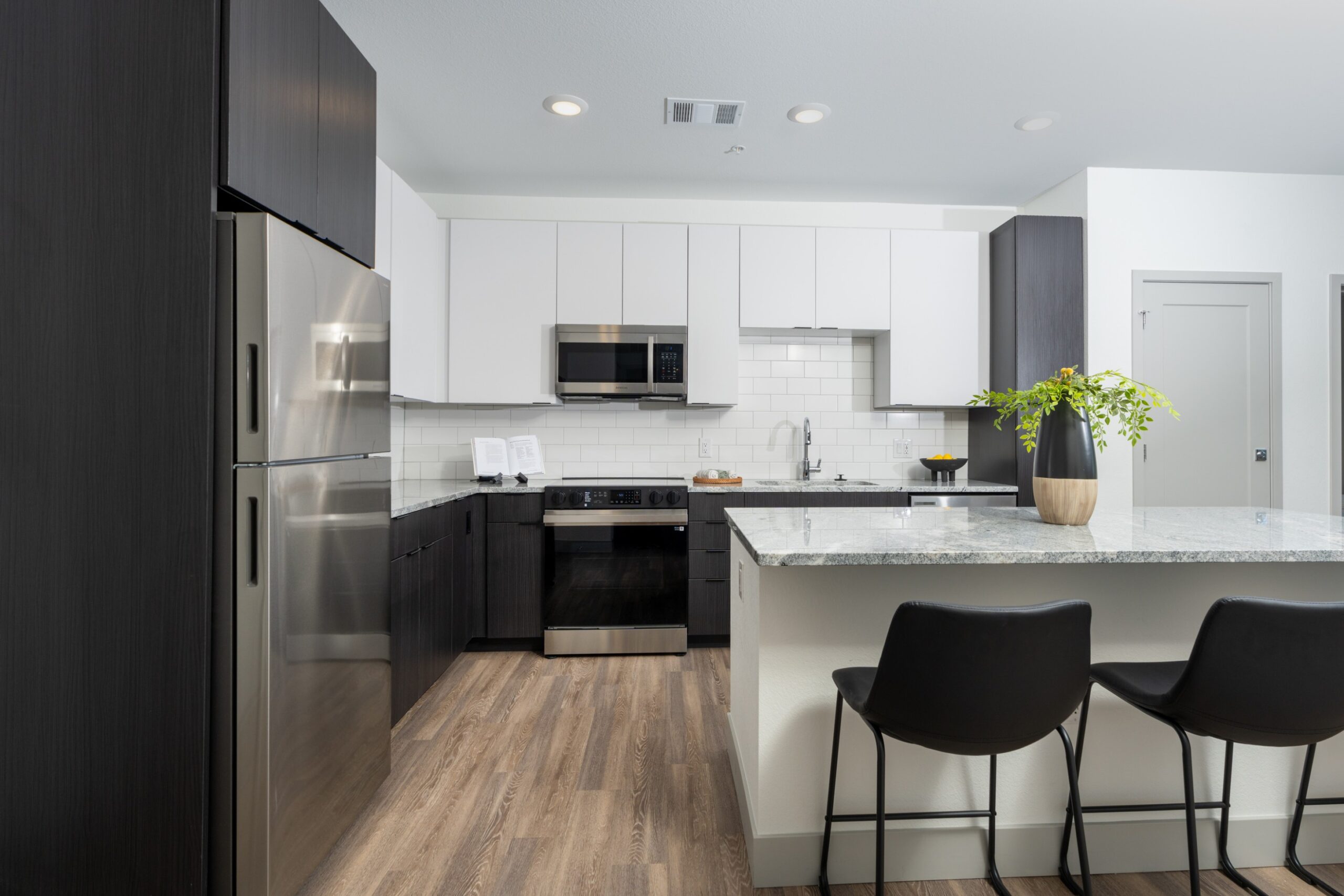 Model kitchen with island and stainless-steel appliances