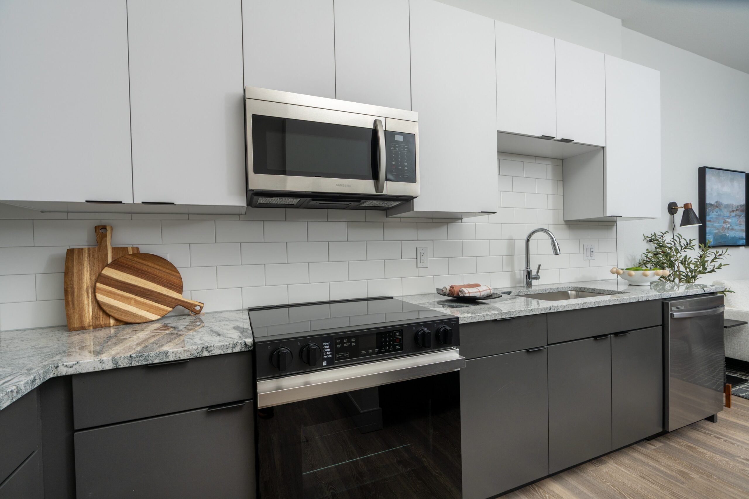Model kitchen with Samsung stainless-steel appliances and tile backsplash