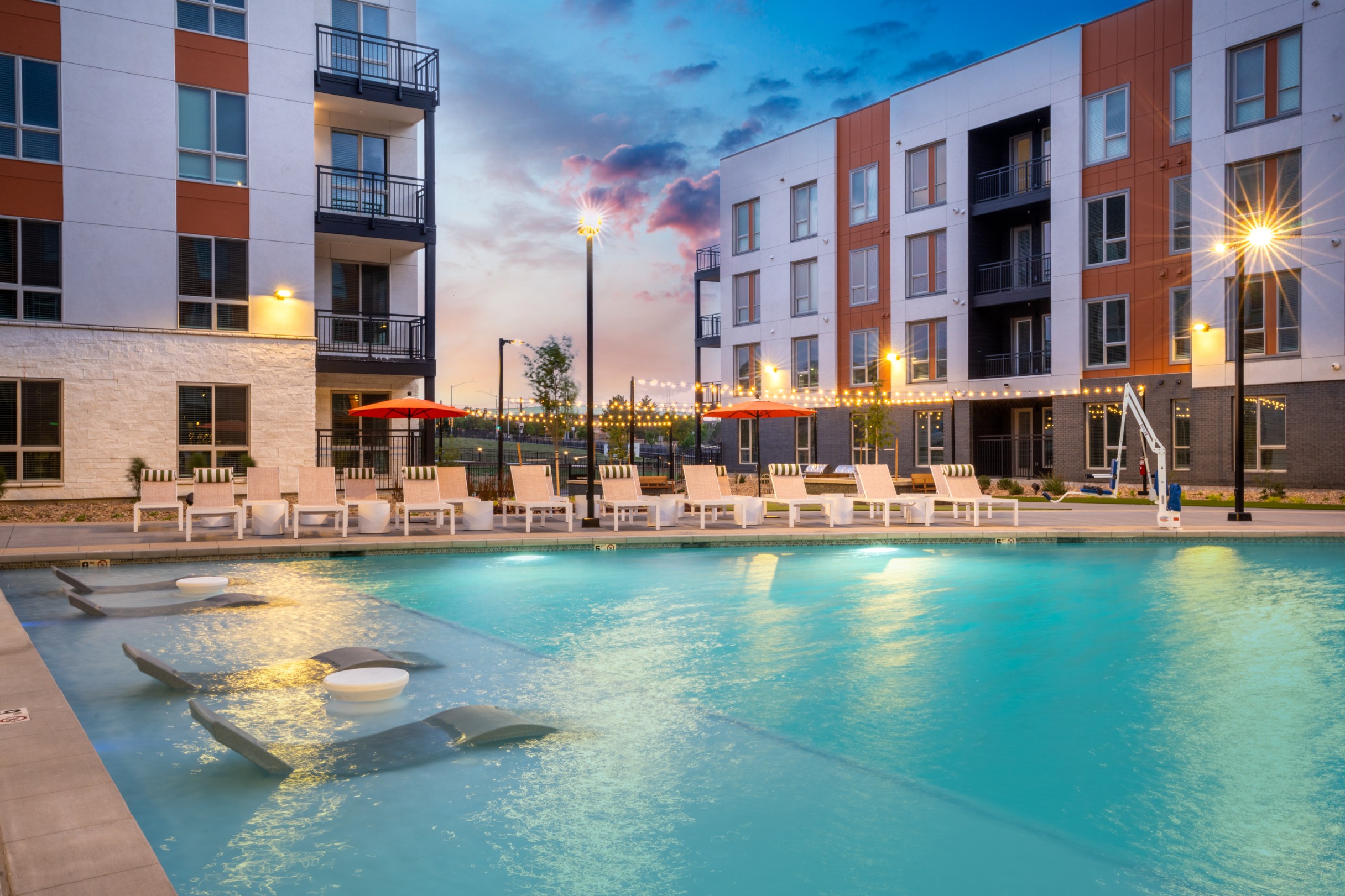 In-pool ledge loungers and sundeck seating at the resort-style swimming pool